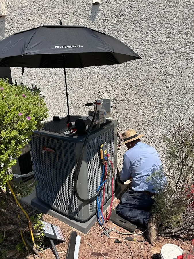 HVAC technician performing outdoor AC maintenance in Medford